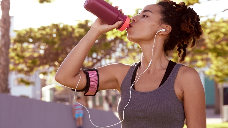 A runner drinking from a sports bottle.