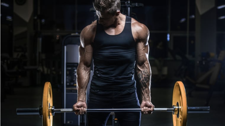 A muscular person lifting a barbell.