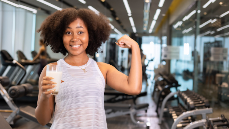 A person drinking milk in the gym.