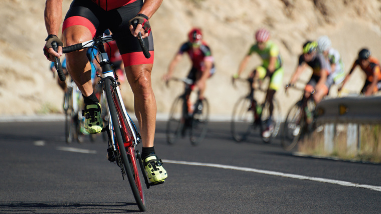 A group of people cycling on a road.