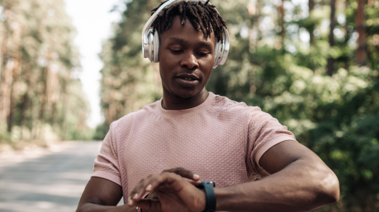 A fit person checking their heart rate on a wrist-worn heart rate monitor.