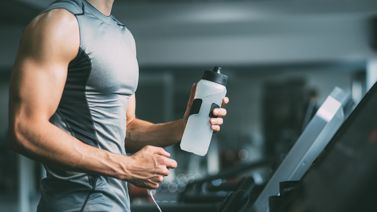 An athlete holding a water bottle.