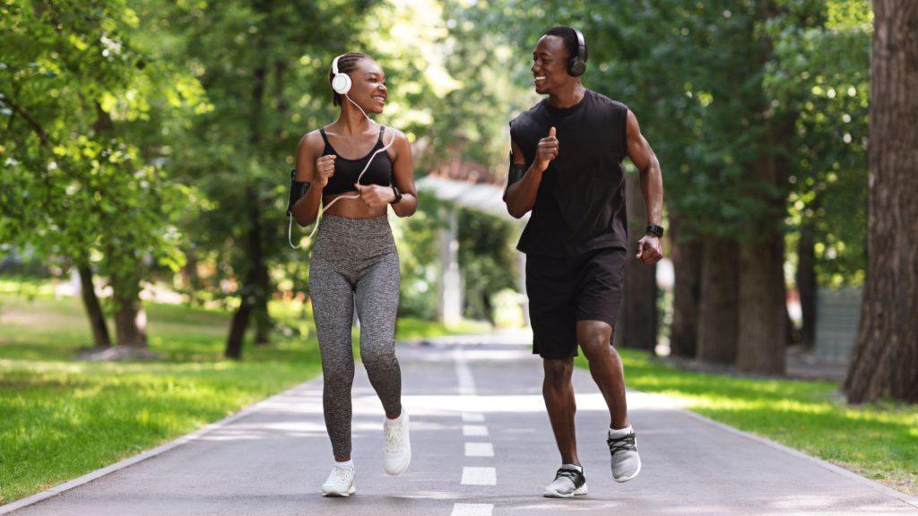 Two fit people running outdoors.