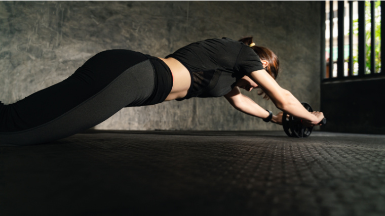 A person doing the ab wheel workout.