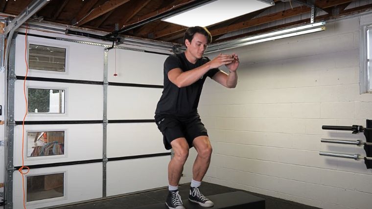 A person performing the box jump exercise.