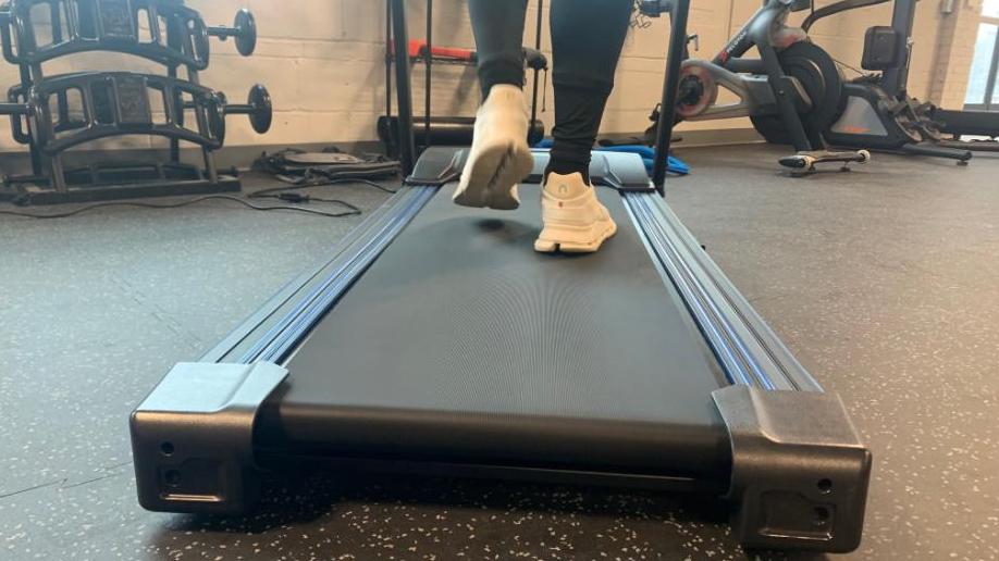 Person walking on treadmill deck