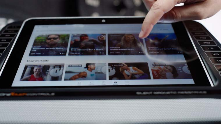 A hand scrolls throught iFit Classes on the NordicTrack Spacesaver SE7i