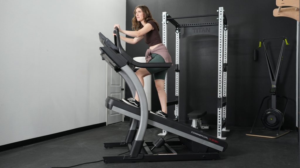 A woman walking at tallest incline on the NordicTrack X22i