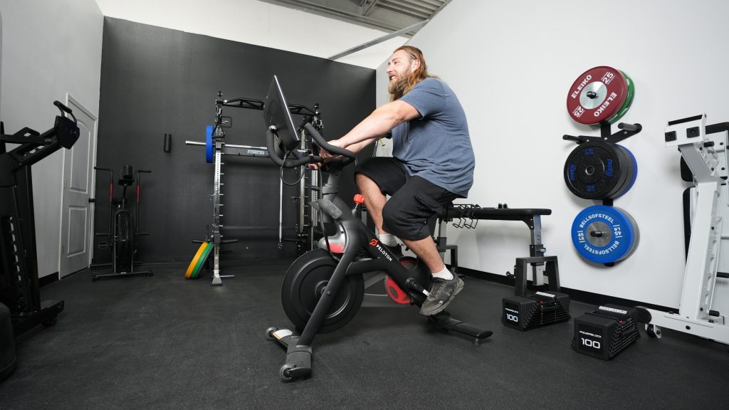 A person riding on a Peloton exercise bike